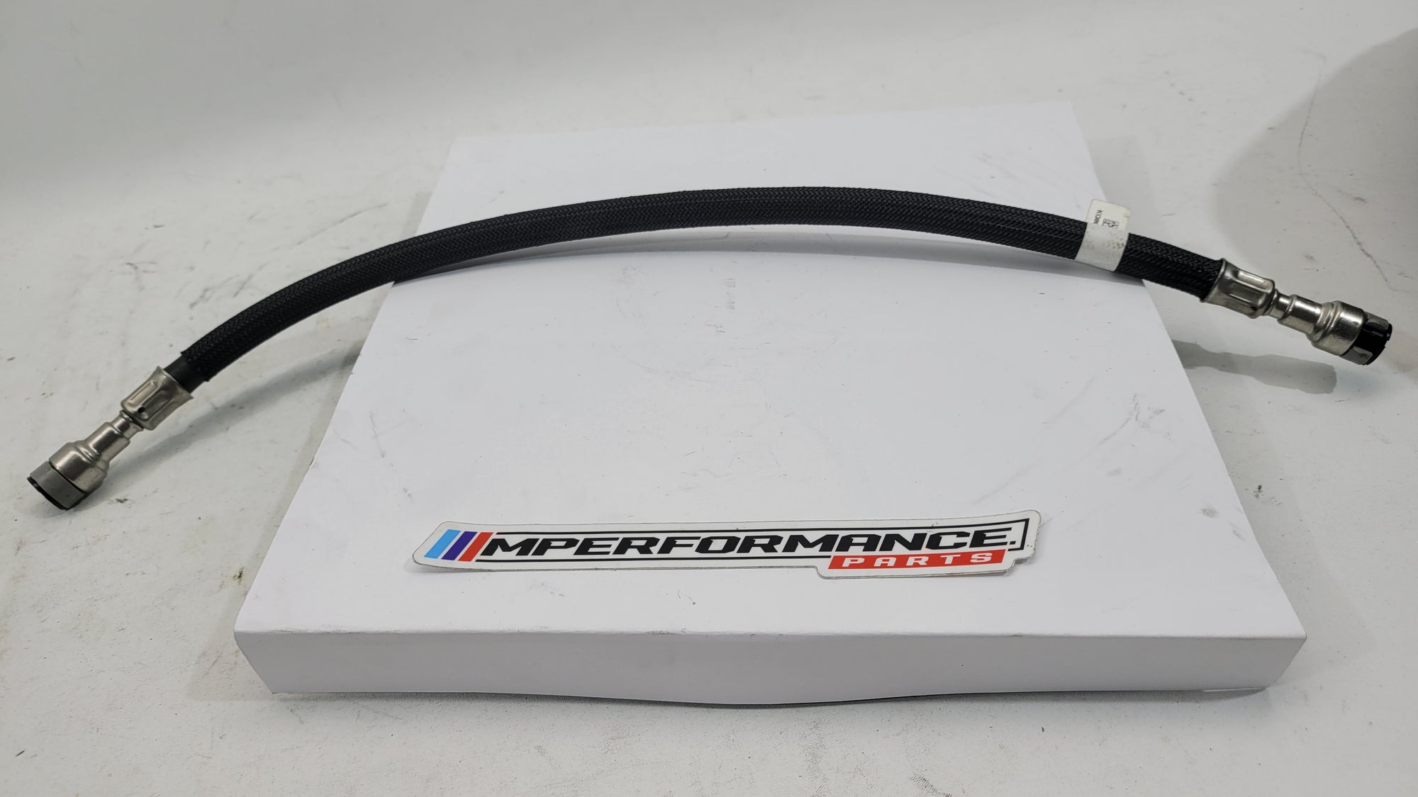 BMW M3 M4 G80 G82 G83 fuel line hose from MPerformance.parts, showing the black rubber hose with metal fittings and connectors.