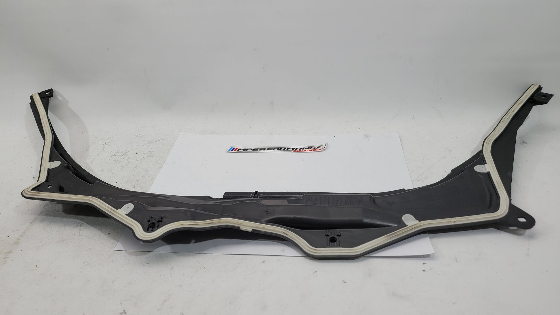 BMW M3 G8X firewall upper section cover panel by MPerformance.parts, showing the sleek black metal engine compartment cover.