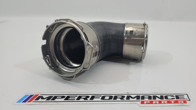 G80 M3 Competition air intake hose pipe from MPerformance.parts, black rubber with metal connectors, designed for engine airflow.