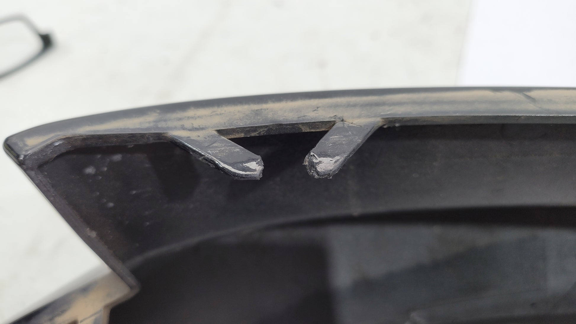 BMW G80 M3 rear bumper left corner spat splitter by MPerformance.parts, showcasing the aerodynamic design and textured finish.