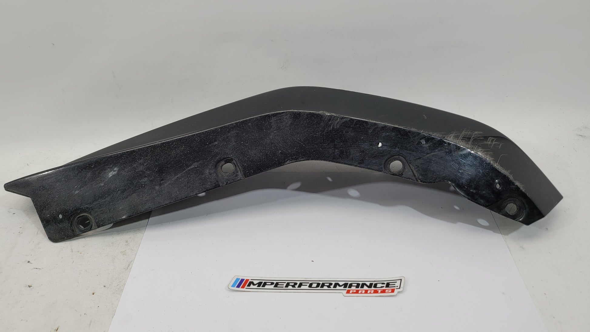 BMW G80 M3 rear bumper left corner spat splitter, black plastic, designed for performance and precise fit.
