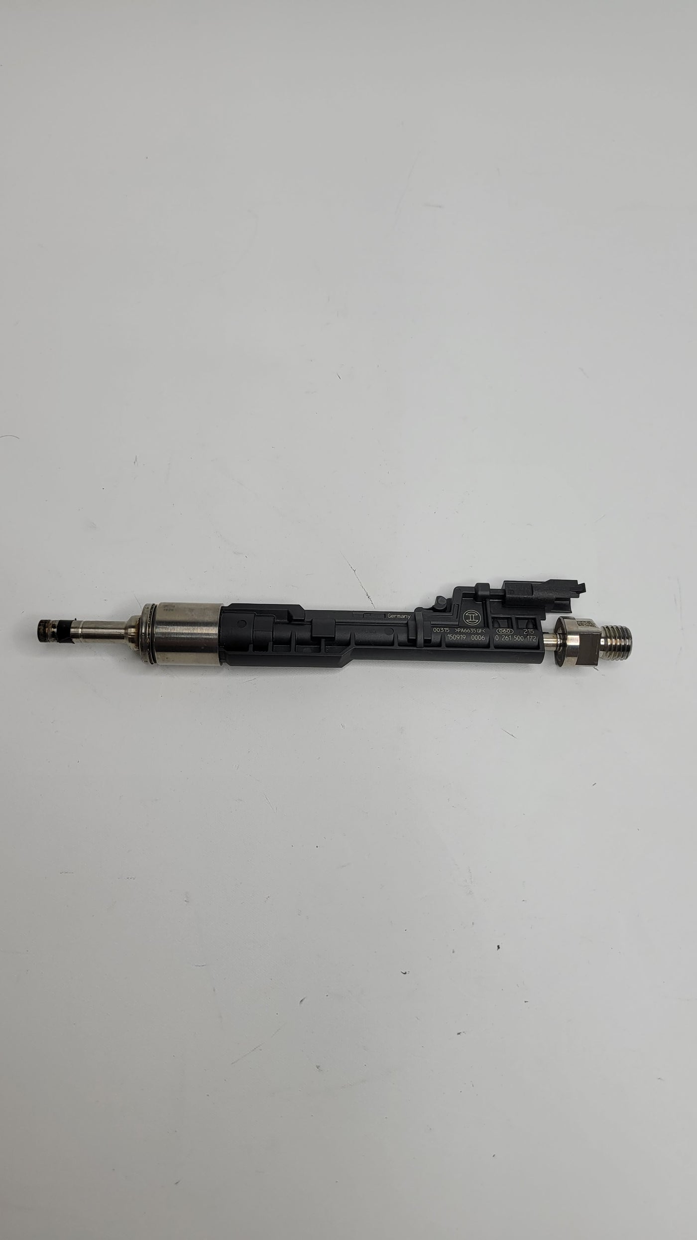 F80 M3 injector from MPerformance.parts with detailed metal components and electrical connections for engine performance.