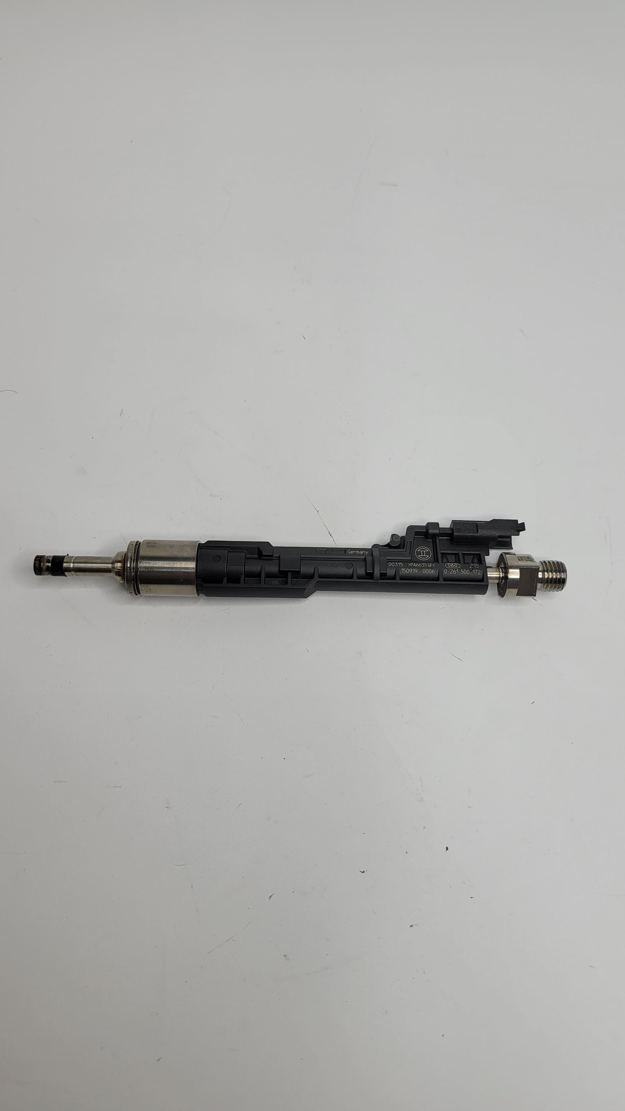 F80 M3 injector from MPerformance.parts with detailed metal components and electrical connections for engine performance.