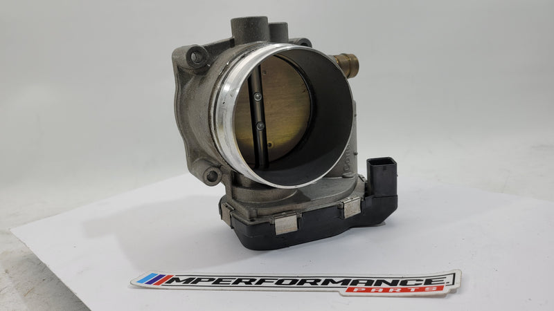 BMW M3 M4 F80 F82 F83 S55 engine throttle body by MPerformance.parts, showing the metal component with mounting points and electronic connections.