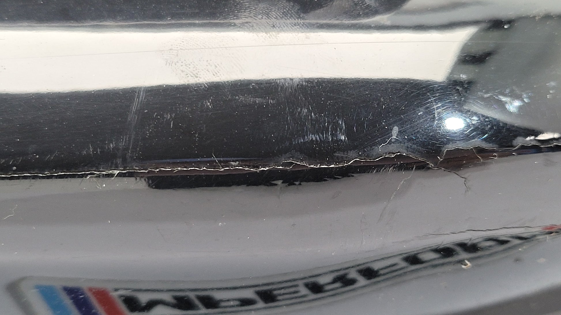 BMW G80 M3 rear bumper left corner spat splitter by MPerformance.parts, featuring black plastic with textured finish.