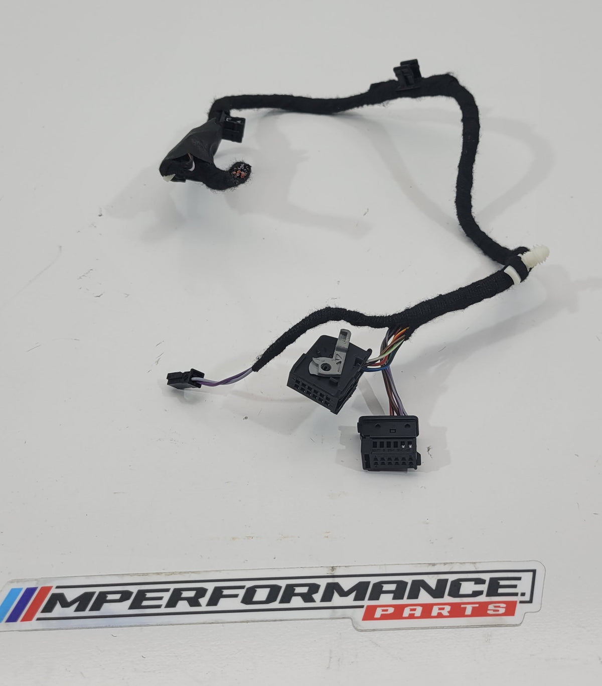 MPerformance.parts flag plugs in black with white branding, designed for automotive use, showing close-up of the product.