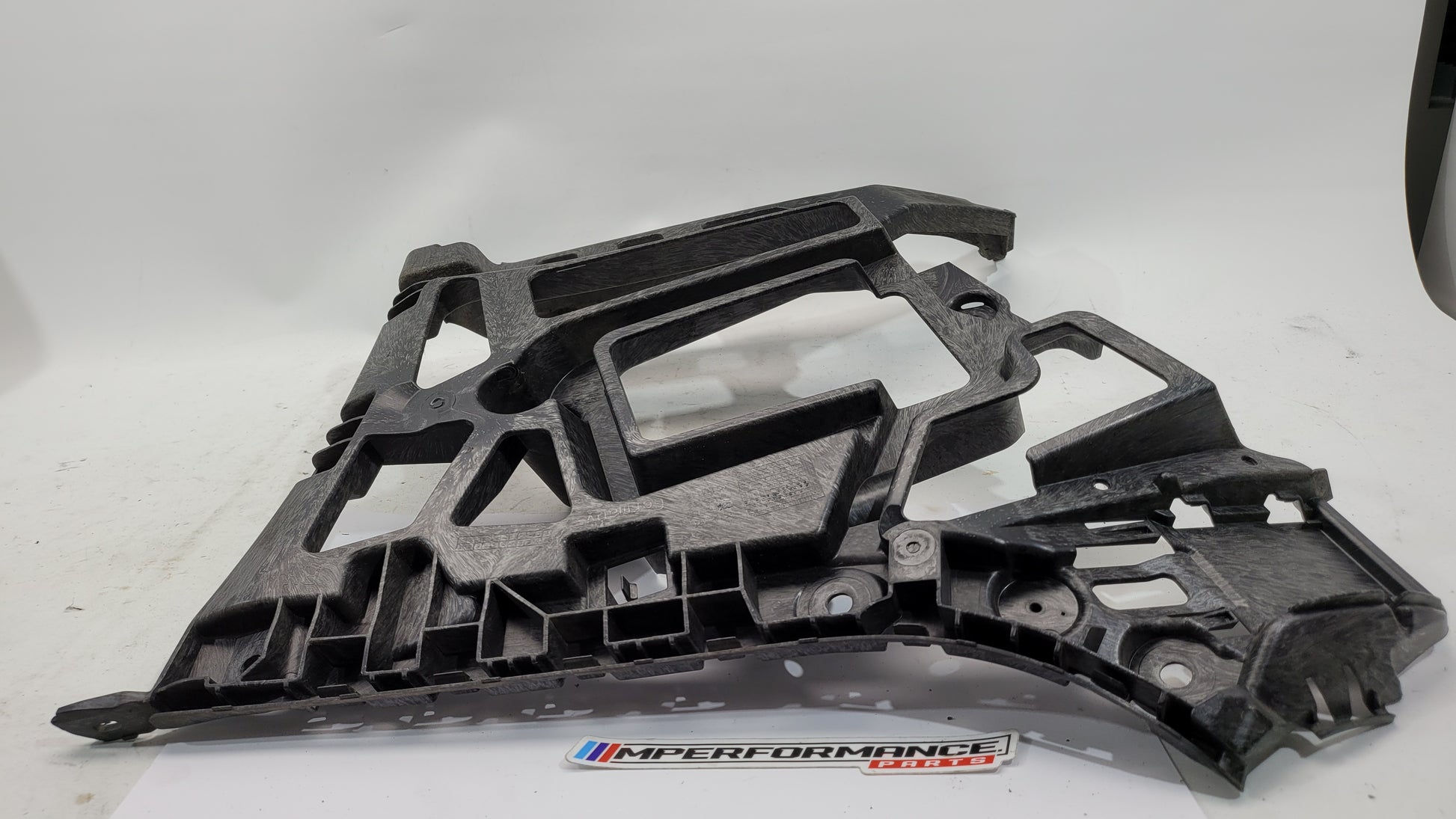 BMW M3 xDrive G80 rear bumper support bracket by MPerformance.parts, showing the metal bracket with mounting points and structural design.
