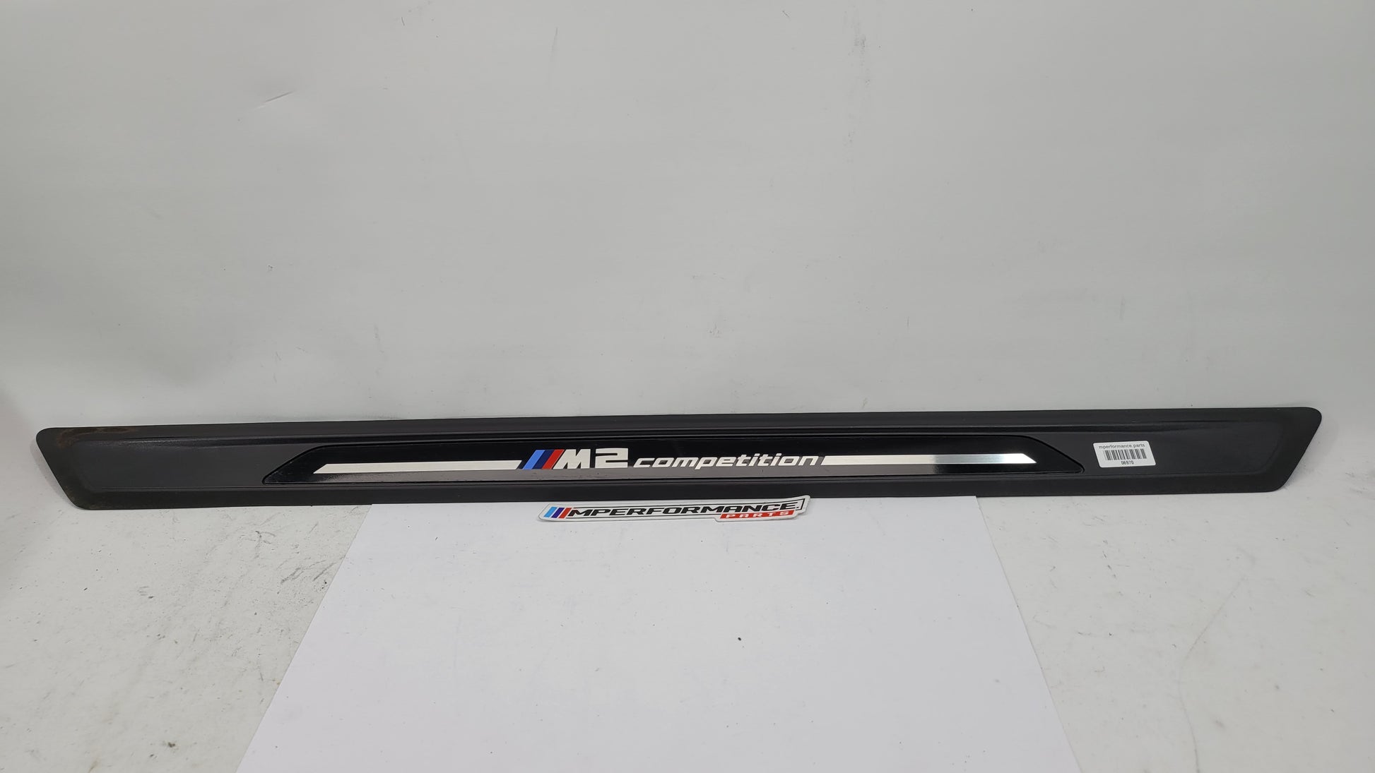 BMW M2 Competition F87 door sill scuff plate, left or right, MPerformance.parts logo, close-up view of the black aluminum plate.
