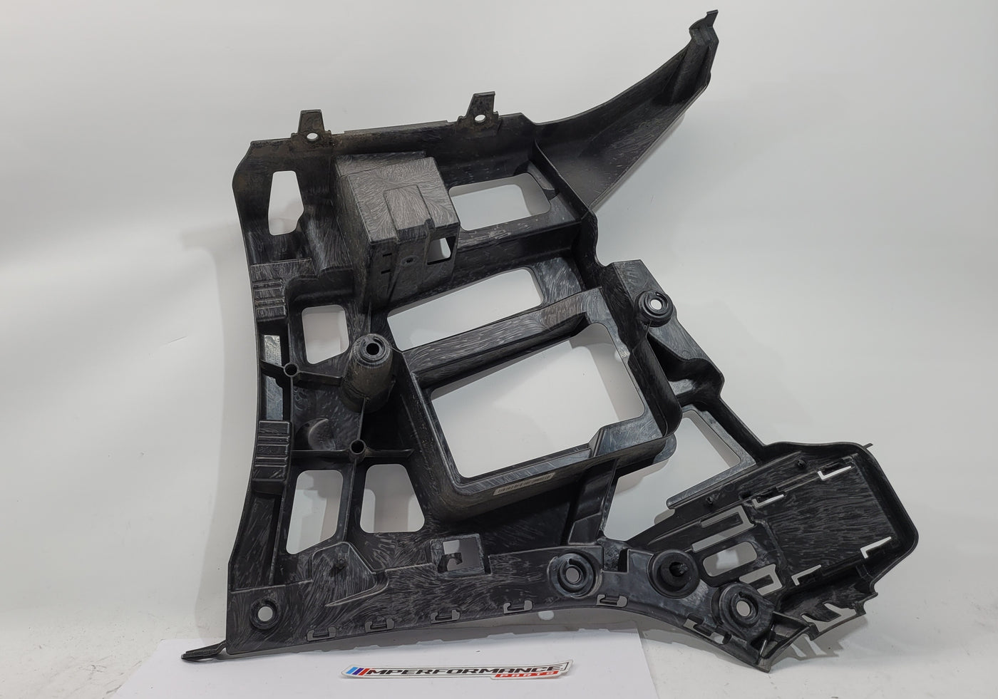 BMW M3 M4 G80 G82 rear left bumper corner bracket by MPerformance.parts, showing the black metal mounting component.