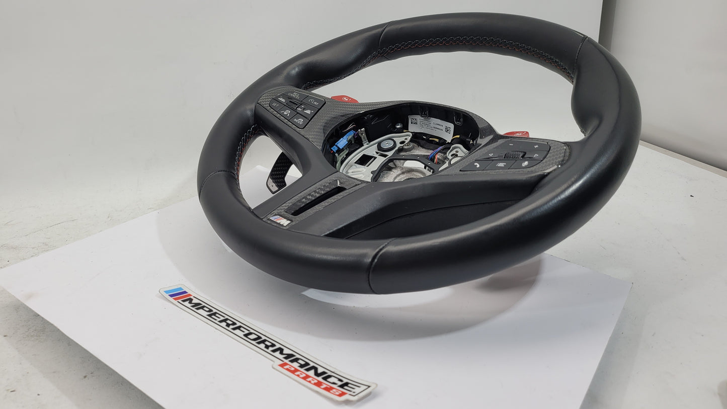 BMW M2 M3 M4 G80 G82 leather M Performance steering wheel with detailed stitching and multifunction controls.