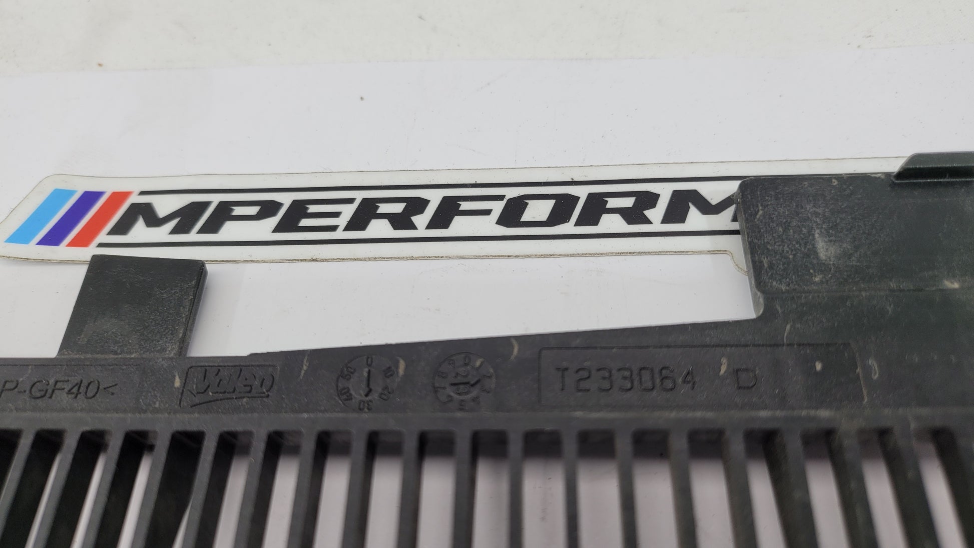 BMW G80 G82 G83 M3 M4 Competition plastic radiator cover shroud by MPerformance.parts, showing the sleek black engine bay component.