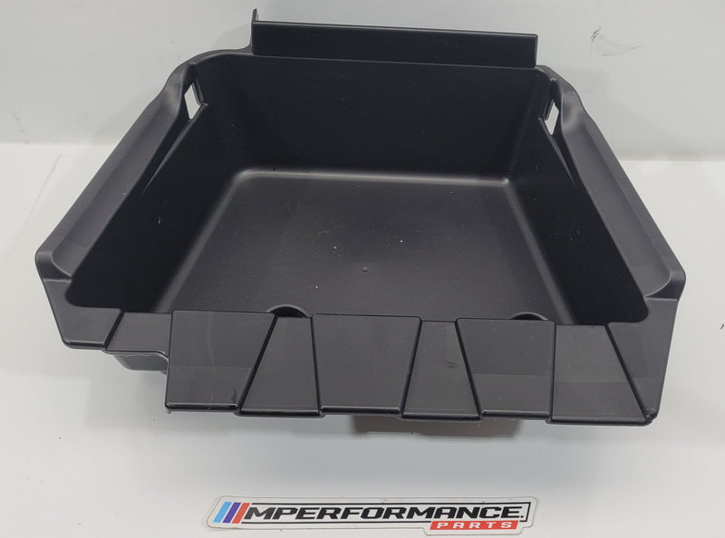 BMW M3 G80 storage compartment trim panel by MPerformance.parts, showing the sleek, black interior trim with precise fit and finish.