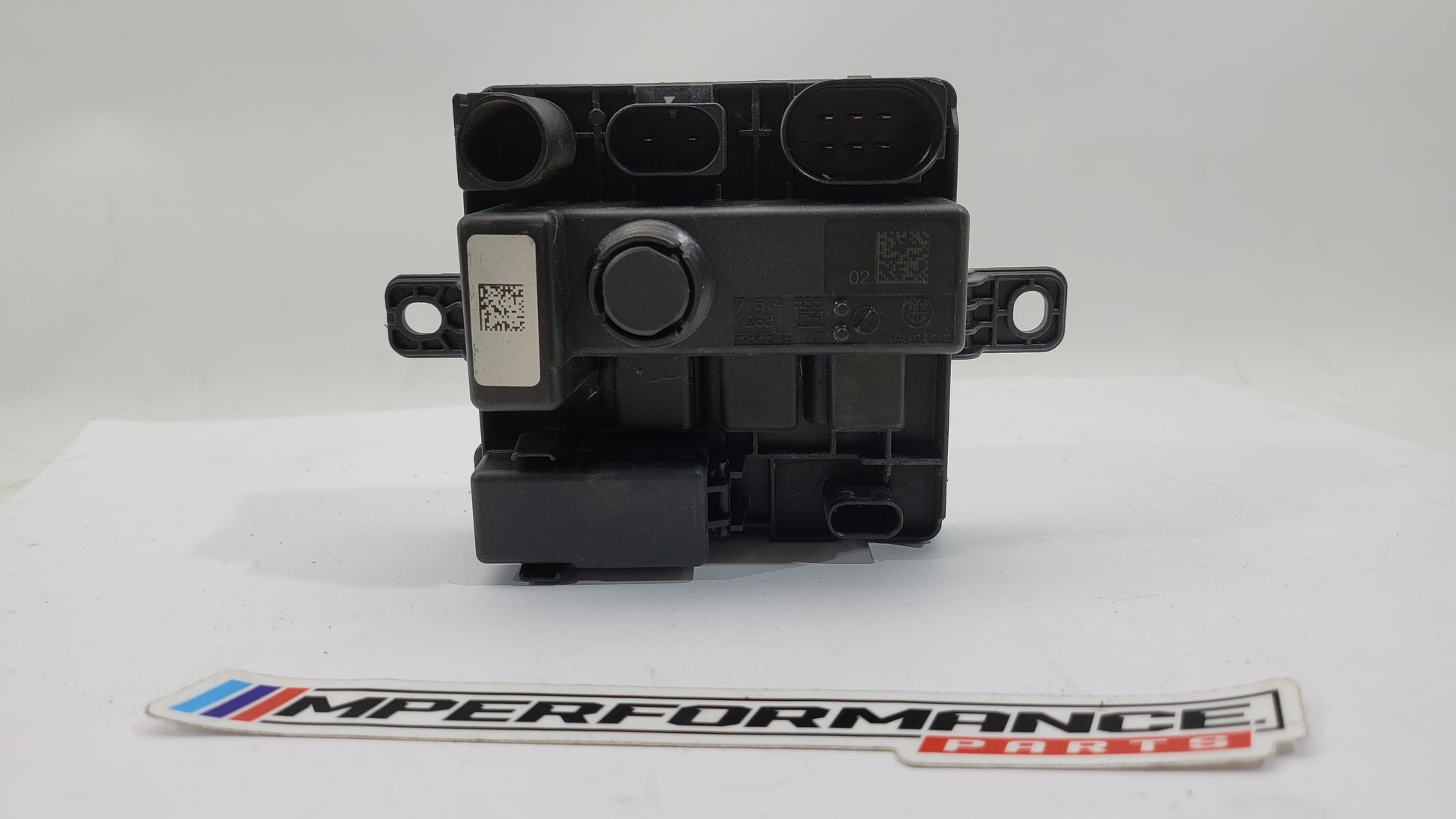 BMW F Series F8x M3 M4 integrated supply module by MPerformance.parts, showing the detailed black component with wiring and connectors.