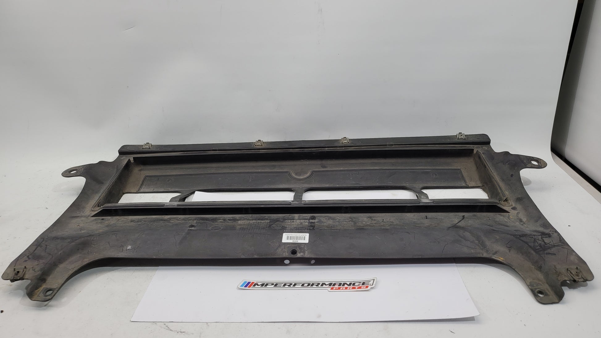 BMW M3 F80 front centre bumper belly pan by MPerformance.parts, showing the black plastic underside part for aerodynamic support.