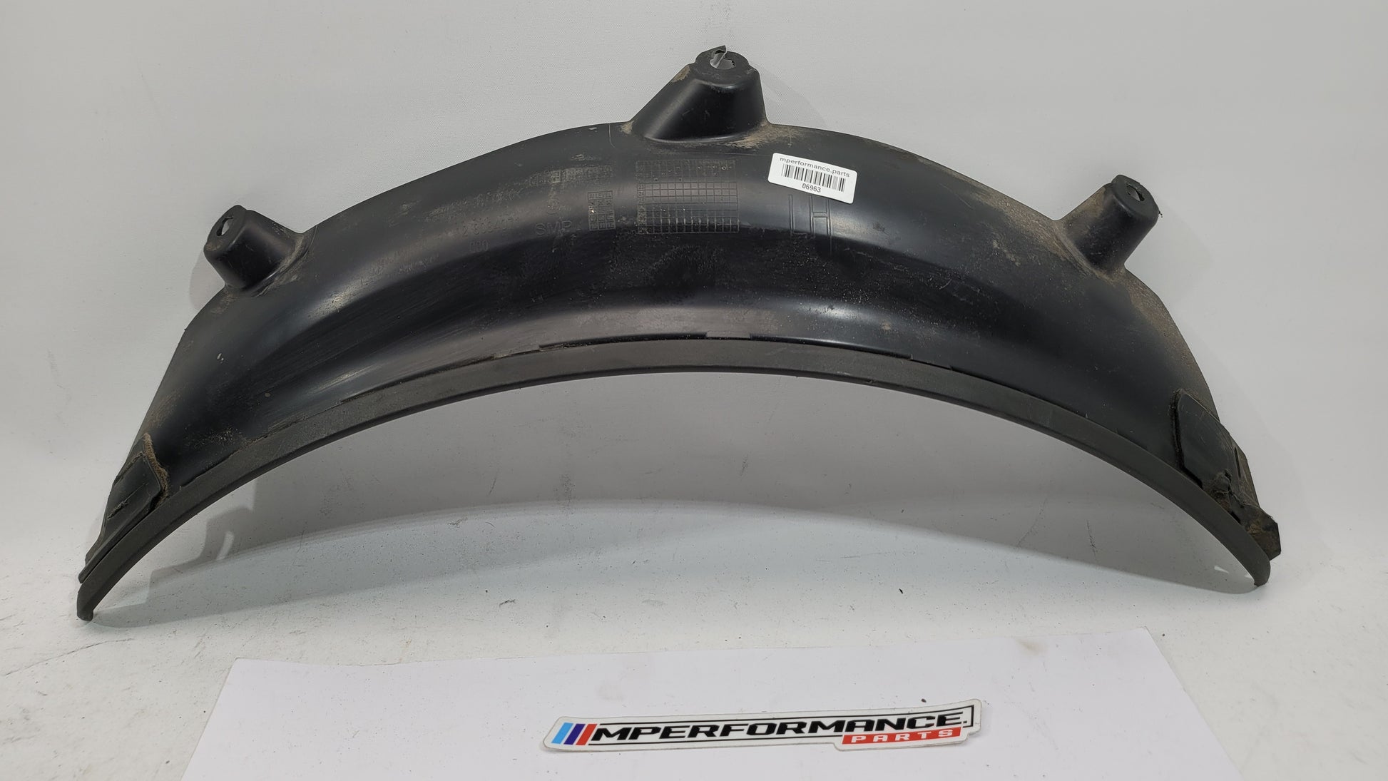 BMW M3 G80 G81 rear left driver side wheel arch trim flaring, MPerformance.parts, close-up of the black protective wheel arch.