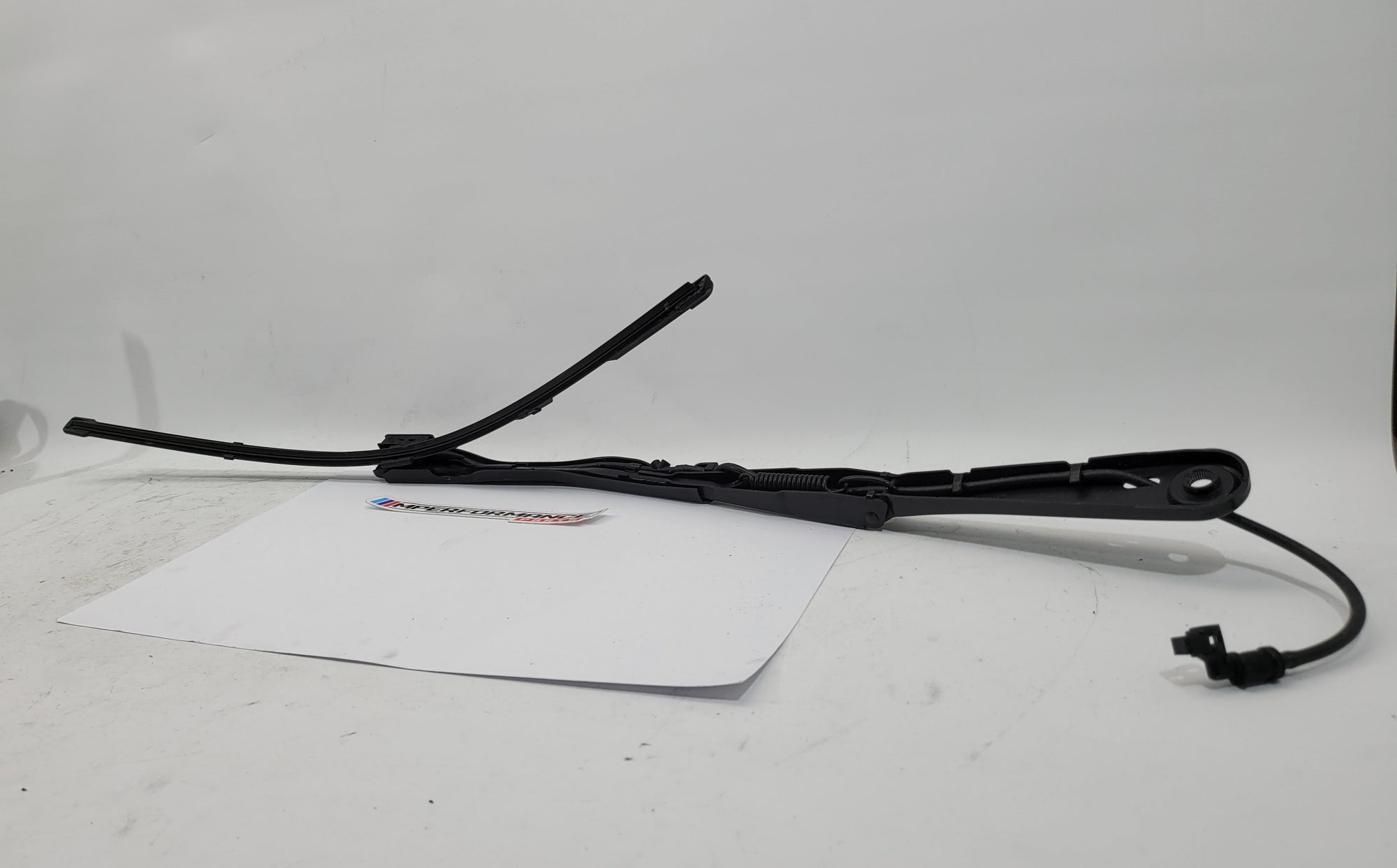 BMW 3 Series G80 M3 driver side front wiper arm by MPerformance.parts, showcasing the metal blade and mounting connection.