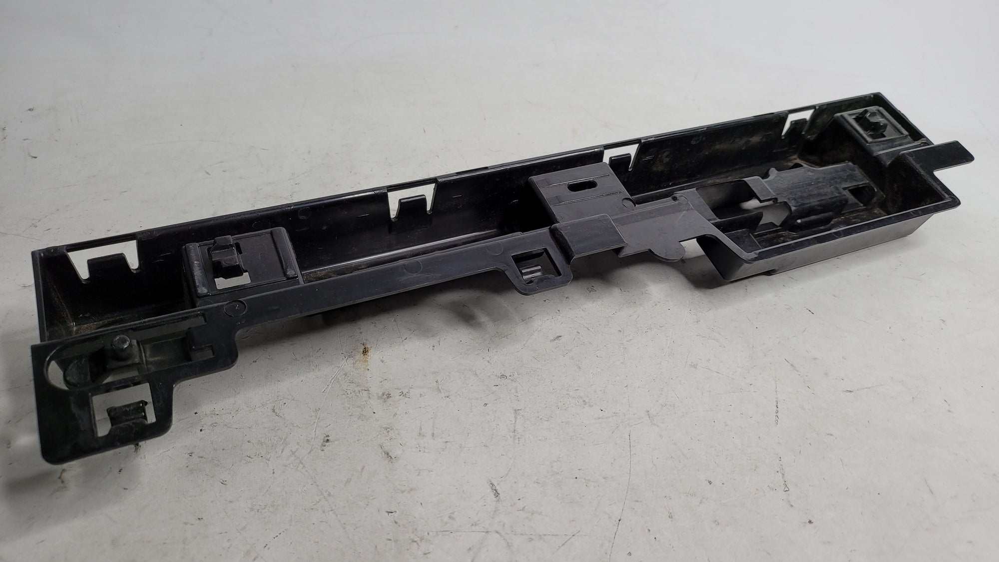 BMW 320i F30 right skirt rocker panel center support bracket by MPerformance.parts, showing the metal mounting component.