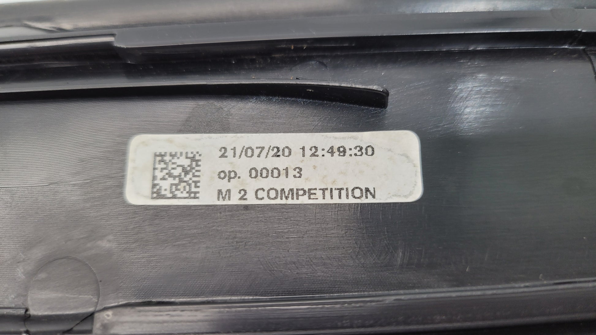BMW M2 Competition F87 door sill scuff plate, left or right, from MPerformance.parts, showing close-up of black protective surface.