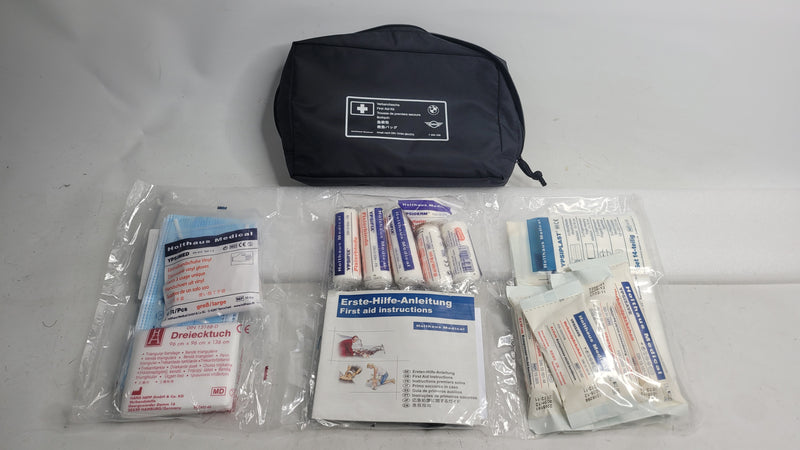 BMW M3 first aid dressing bag by MPerformance.parts, featuring compact design and BMW M3 branding with medical supplies inside.