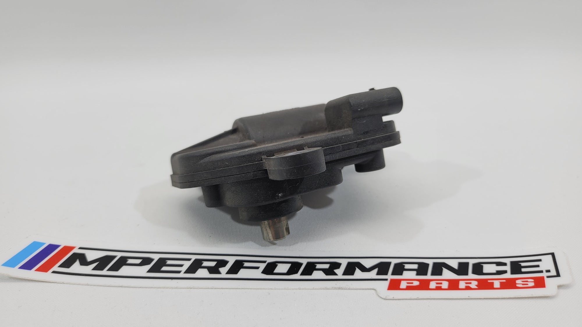 BMW 3 Series G80 G81 G82 M3 M4 exhaust flap actuator by MPerformance.parts, showing the metal component with electrical connections.