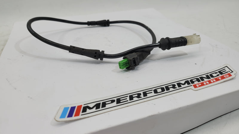 BMW M4 Competition right rear strut height sensor, part number 8091443, close-up showing sensor and mounting details.