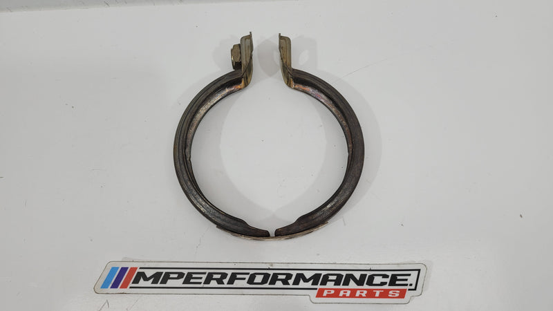 BMW M4 F82 exhaust pipe clamp from MPerformance.parts, showing the metal clamp with mounting details and branding.