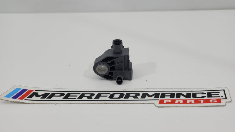 BMW G-Series crash sensor 9496815 by MPerformance.parts, showing the compact, black automotive crash sensor with mounting components.