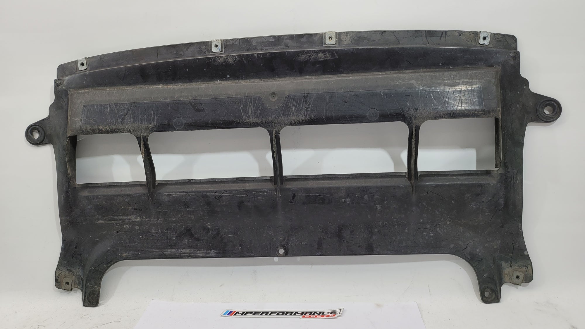 BMW M3 F80 front centre bumper belly pan by MPerformance.parts, showing the black plastic underside component with mounting points.