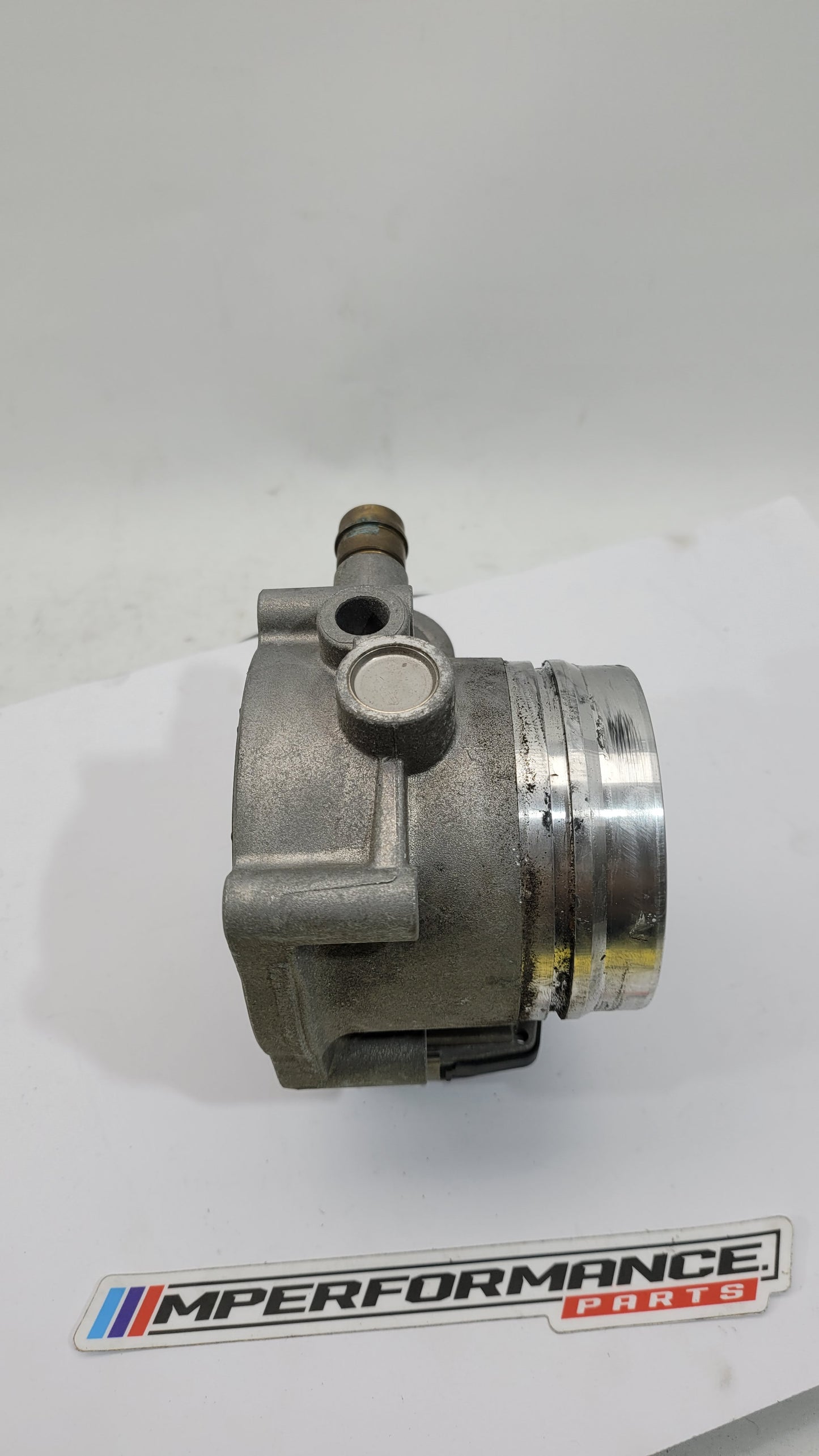 BMW M3 M4 F80 F82 F83 S55 engine throttle body by MPerformance.parts, showing the metal component with mounting details.