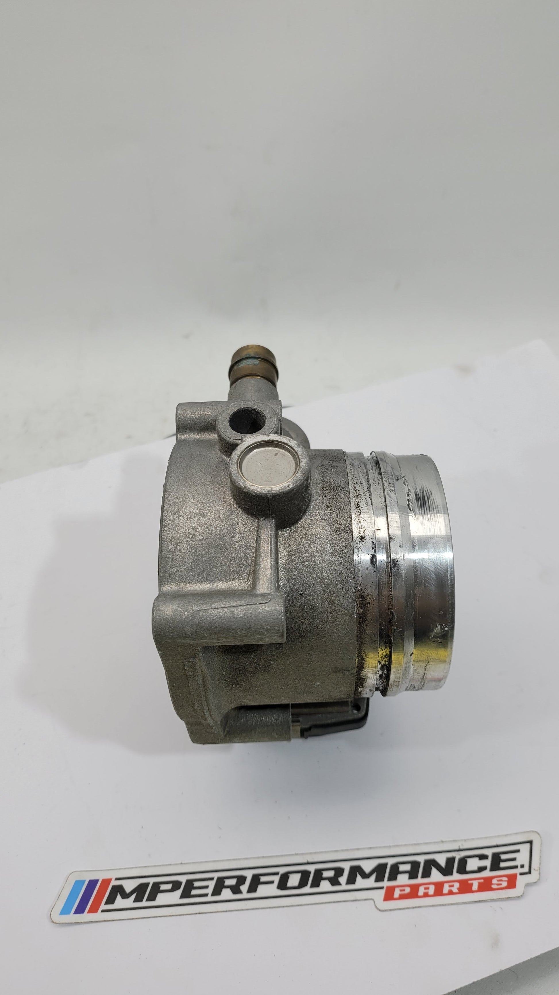 BMW M3 M4 F80 F82 F83 S55 engine throttle body by MPerformance.parts, showing the metal component with mounting details.