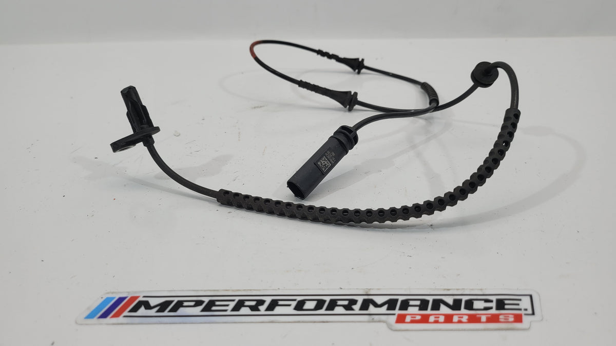 BMW G82 M4 Competition left front driver ABS sensor, OEM part with sensor and wiring visible, designed for vehicle safety and brake system.