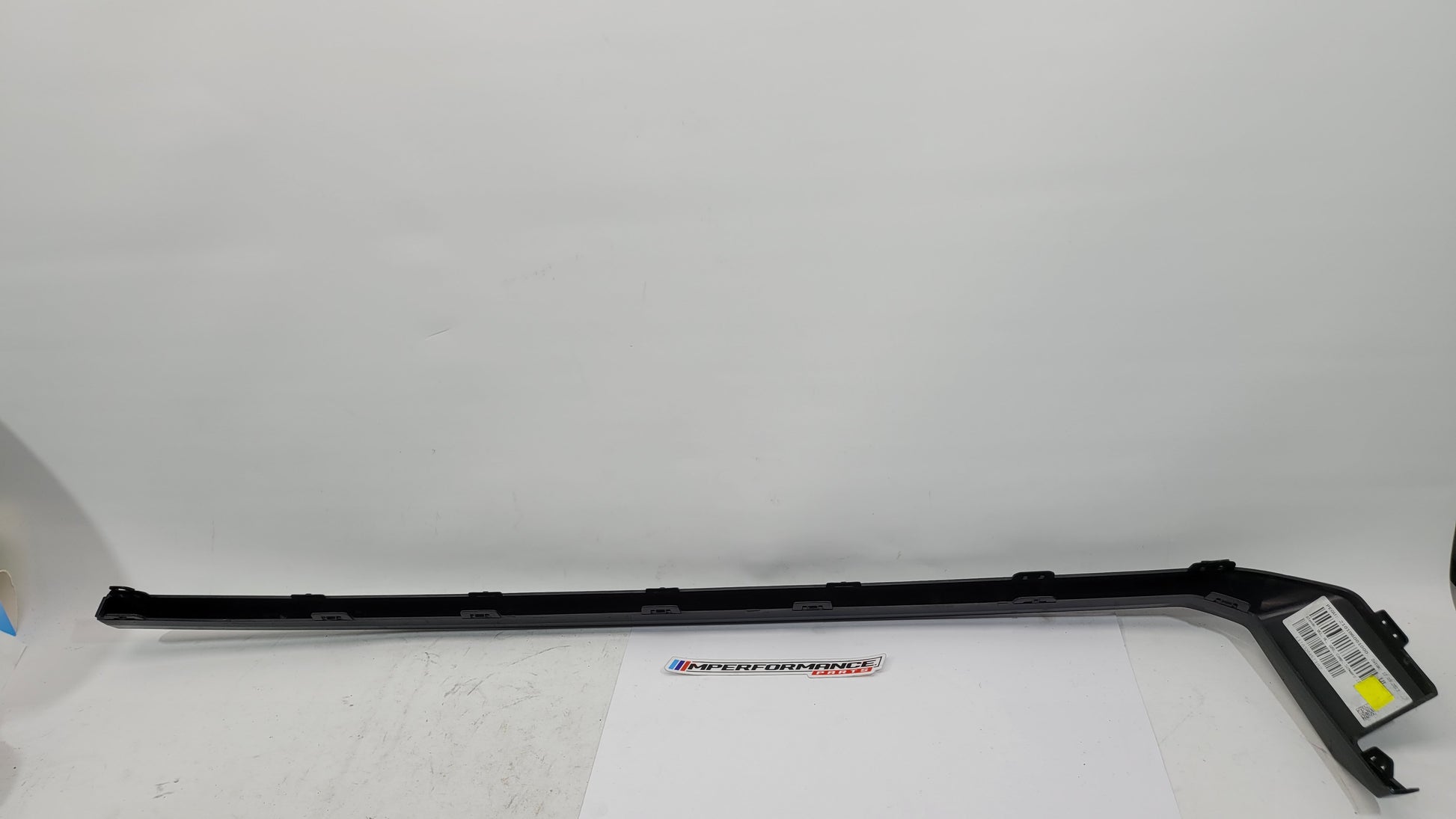 BMW M3 M4 G80 G82 rear bumper left diffuser molding trim from MPerformance.parts, showing the black plastic trim piece.