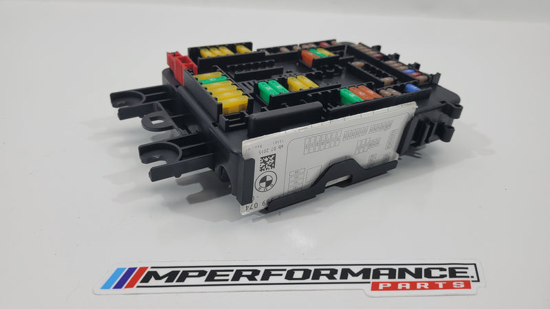 BMW F80 M3 fuse box 9389070 from MPerformance.parts, showing the black plastic fuse box with visible electrical connections.