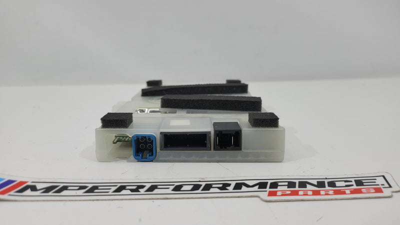 Telematics communication computer control module unit by MPerformance.parts, showing a compact electronic control device with connectors.
