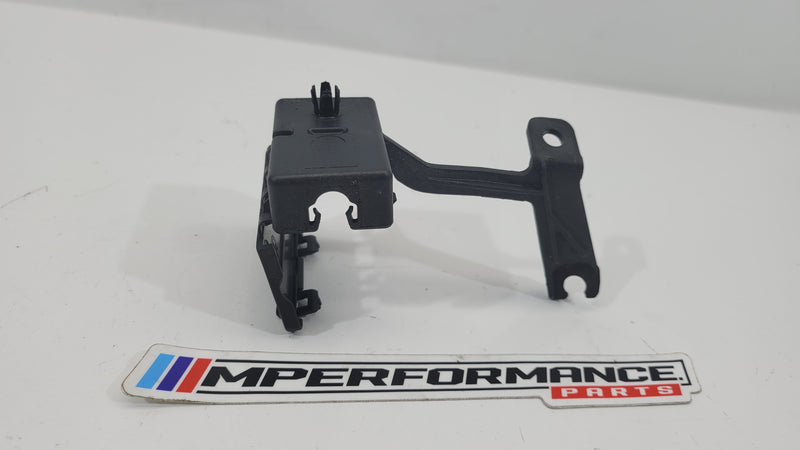 BMW M4 G82 shock absorber plug mount right by MPerformance.parts, showing the black metal component attached to the suspension system.