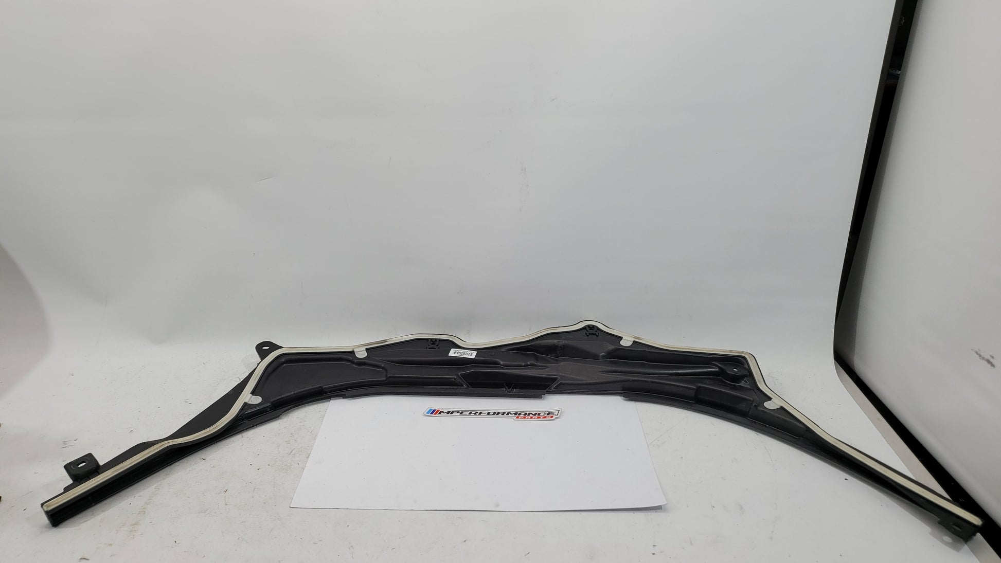 BMW M3 G8X firewall upper section cover panel by MPerformance.parts, showing the black metal engine bay cover with mounting details.