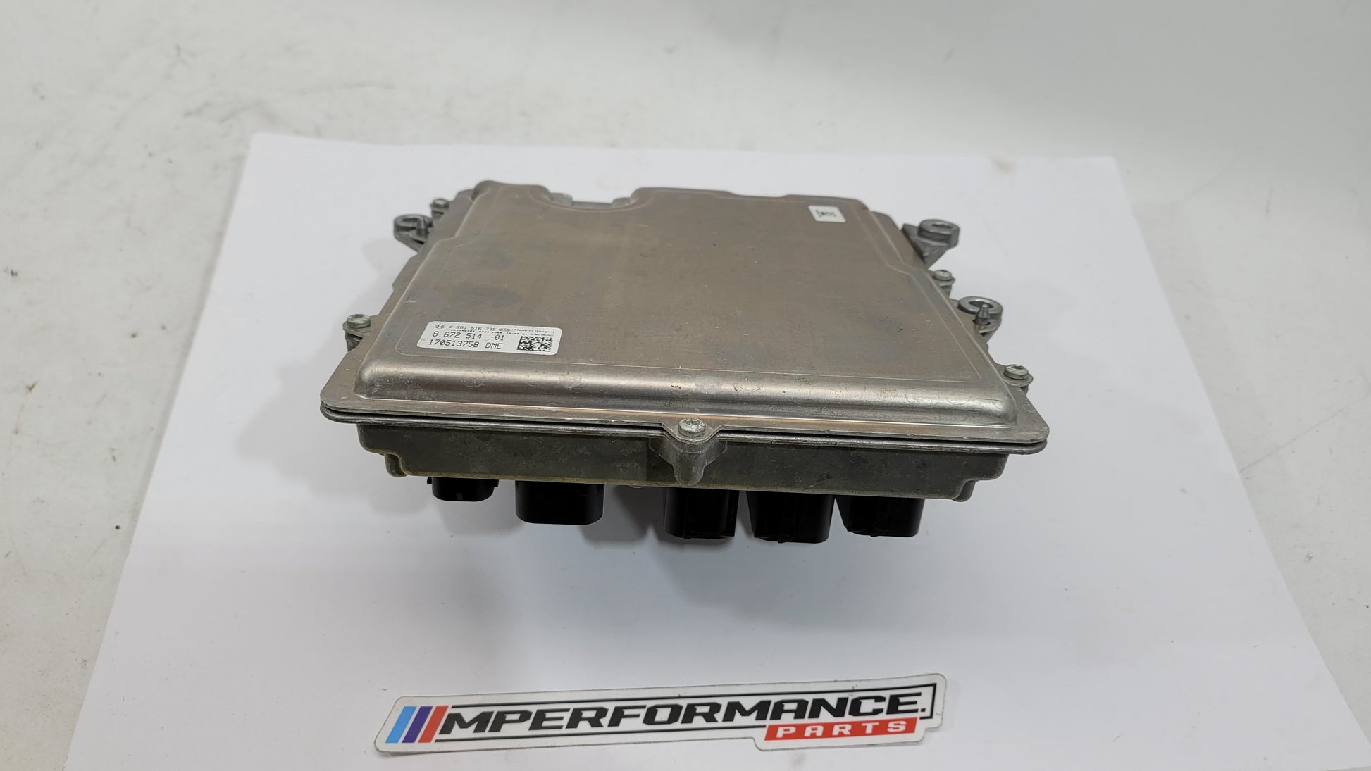 BMW M4 F82 3.0 petrol engine control module by MPerformance.parts, showing the black electronic module with connectors and branding.