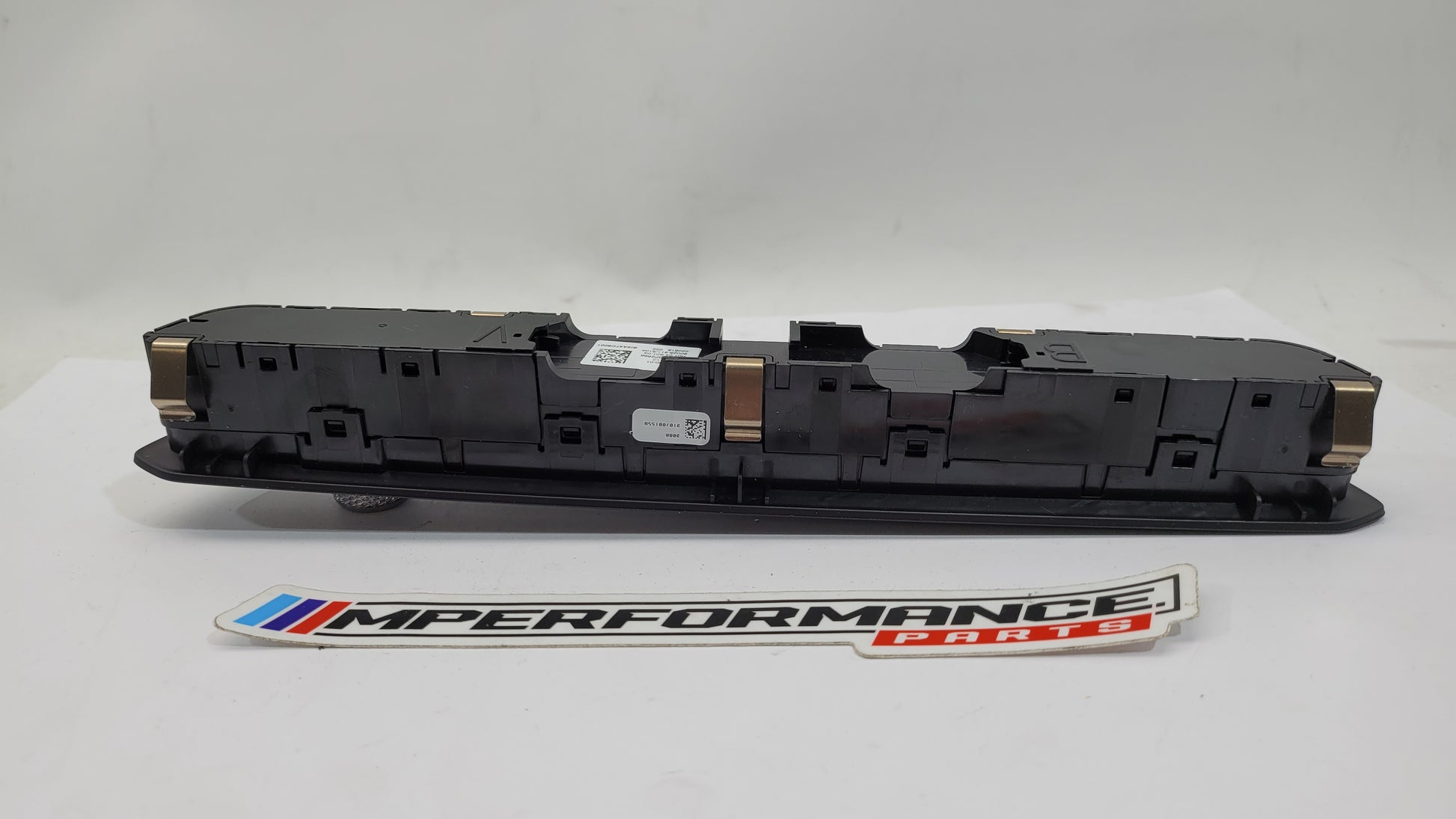 BMW G22 G80 M3 Competition radio control trim part by MPerformance.parts, showcasing the sleek, black interior trim piece.