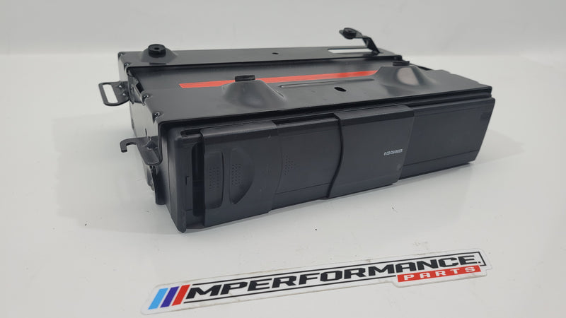 BMW E81 E87 E90 E91 E92 6-disc CD changer by MPerformance.parts, showing the black plastic casing and disc slots.