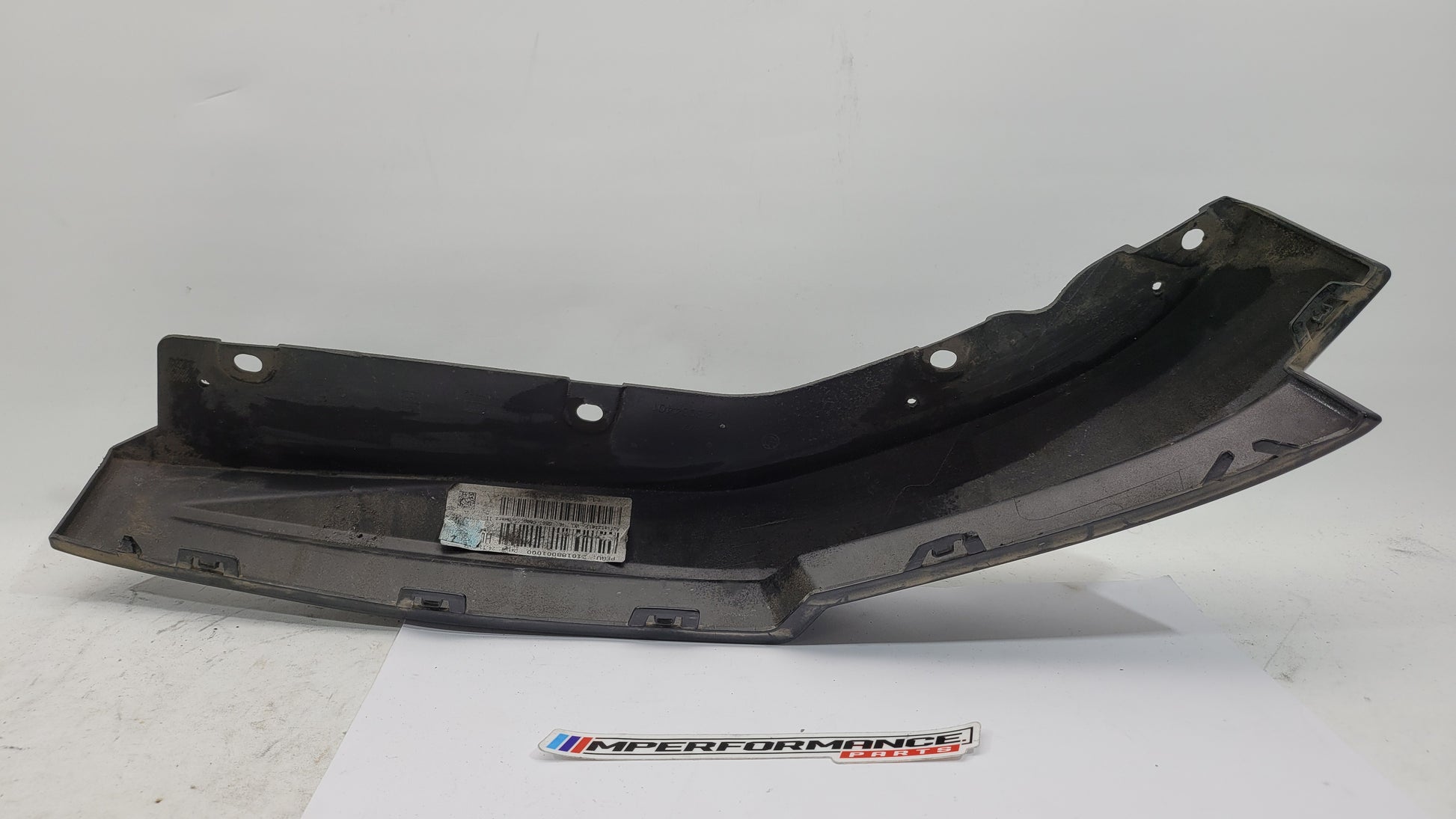 BMW G80 M3 rear bumper left corner spat splitter, MPerformance.parts brand, with aerodynamic design and mounting details.