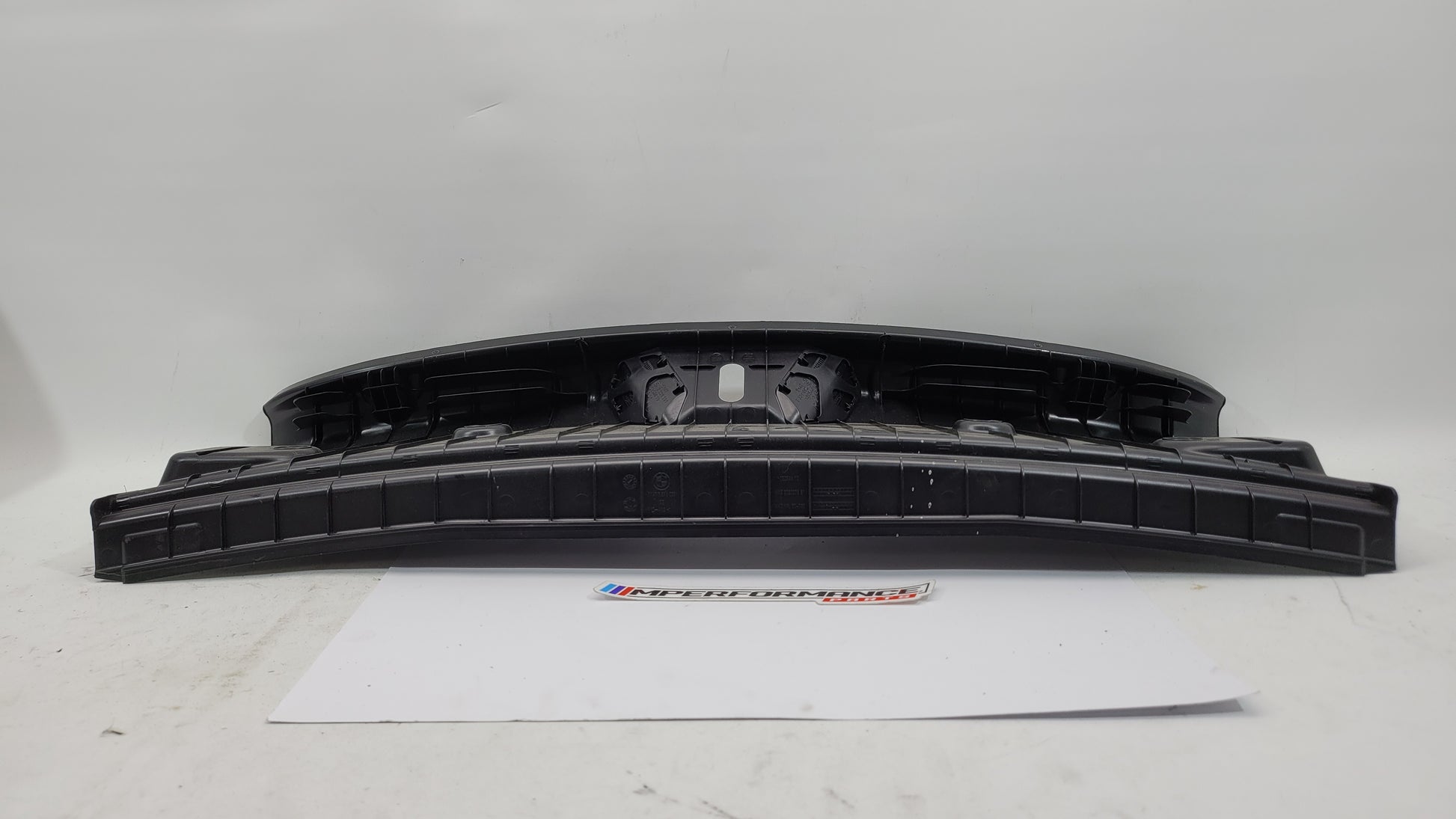 BMW 2 Series F22 and F87 coupe trunk lock trim in black with MPerformance.parts logo, designed for authentic fit and finish.