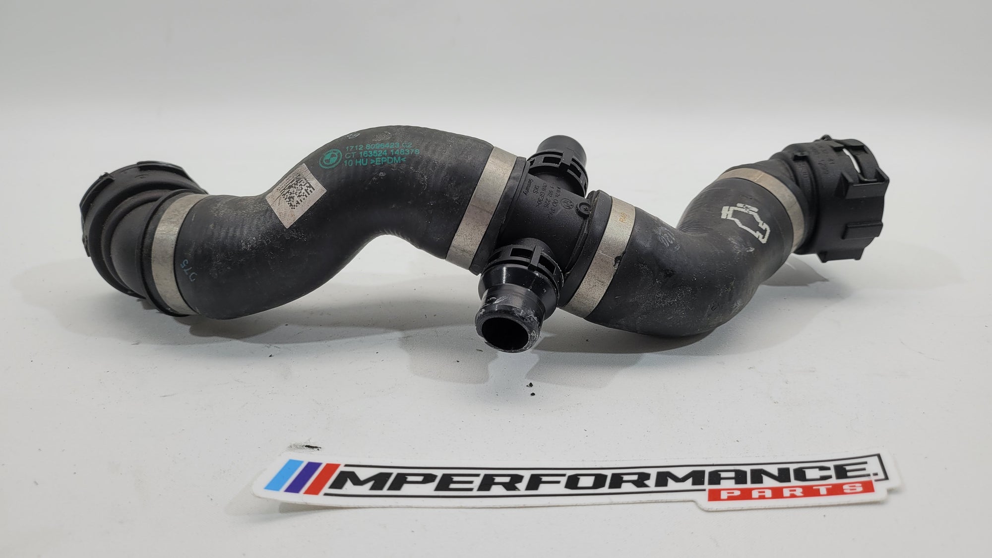 BMW 4 Series M4 Competition G82 engine water coolant hose pipe by MPerformance.parts, close-up of the black flexible hose.