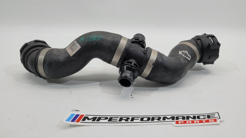 BMW 4 Series M4 Competition G82 engine water coolant hose pipe by MPerformance.parts, close-up of the black flexible hose.