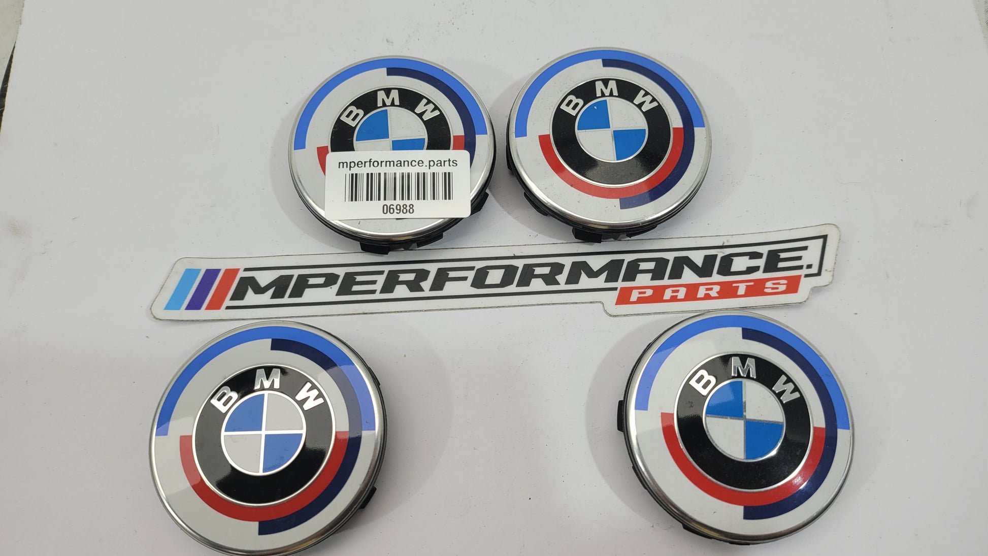 BMW 50th Anniversary G80 wheel cap set of 4 by MPerformance.parts, featuring silver caps with anniversary logo on each wheel.