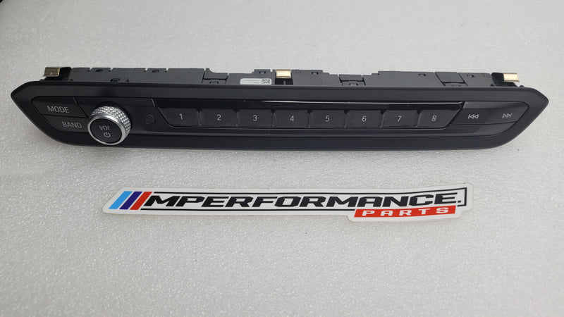 BMW radio deck switch panel G8x M3/4 with MPerformance.parts branding, showing the black switch panel with labeled buttons.