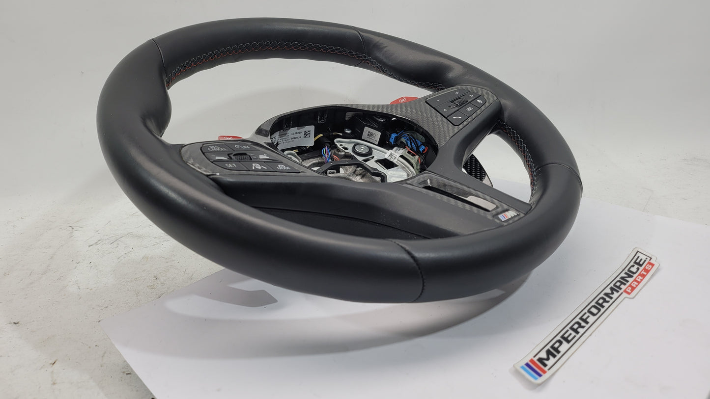 BMW M2 M3 M4 G80 G82 leather M steering wheel with black finish and MPerformance.parts branding, close-up view of the steering wheel.