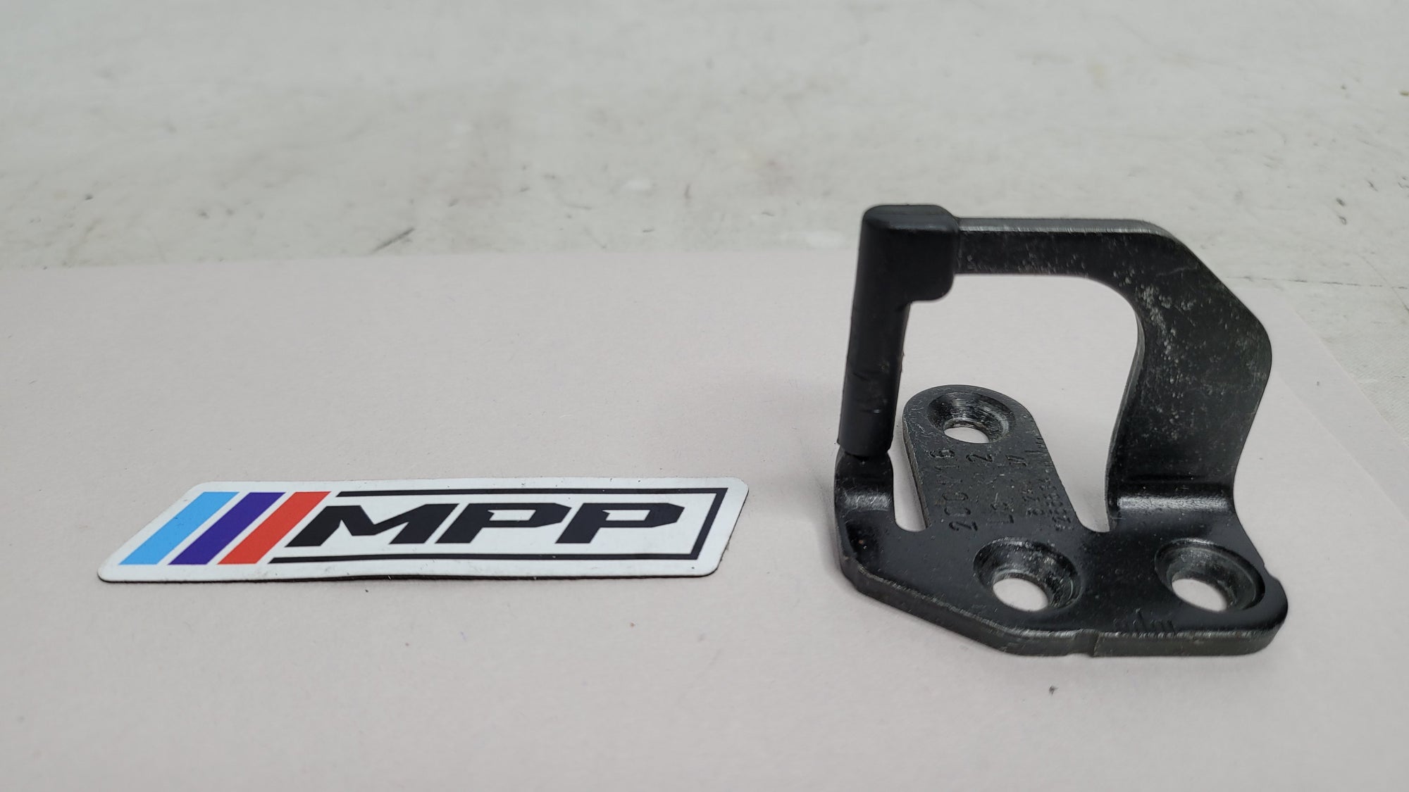 BMW 3 4 Series F30 F80 F32 F82 trunk boot lid striker lock by MPerformance.parts, showing the metal lock component.