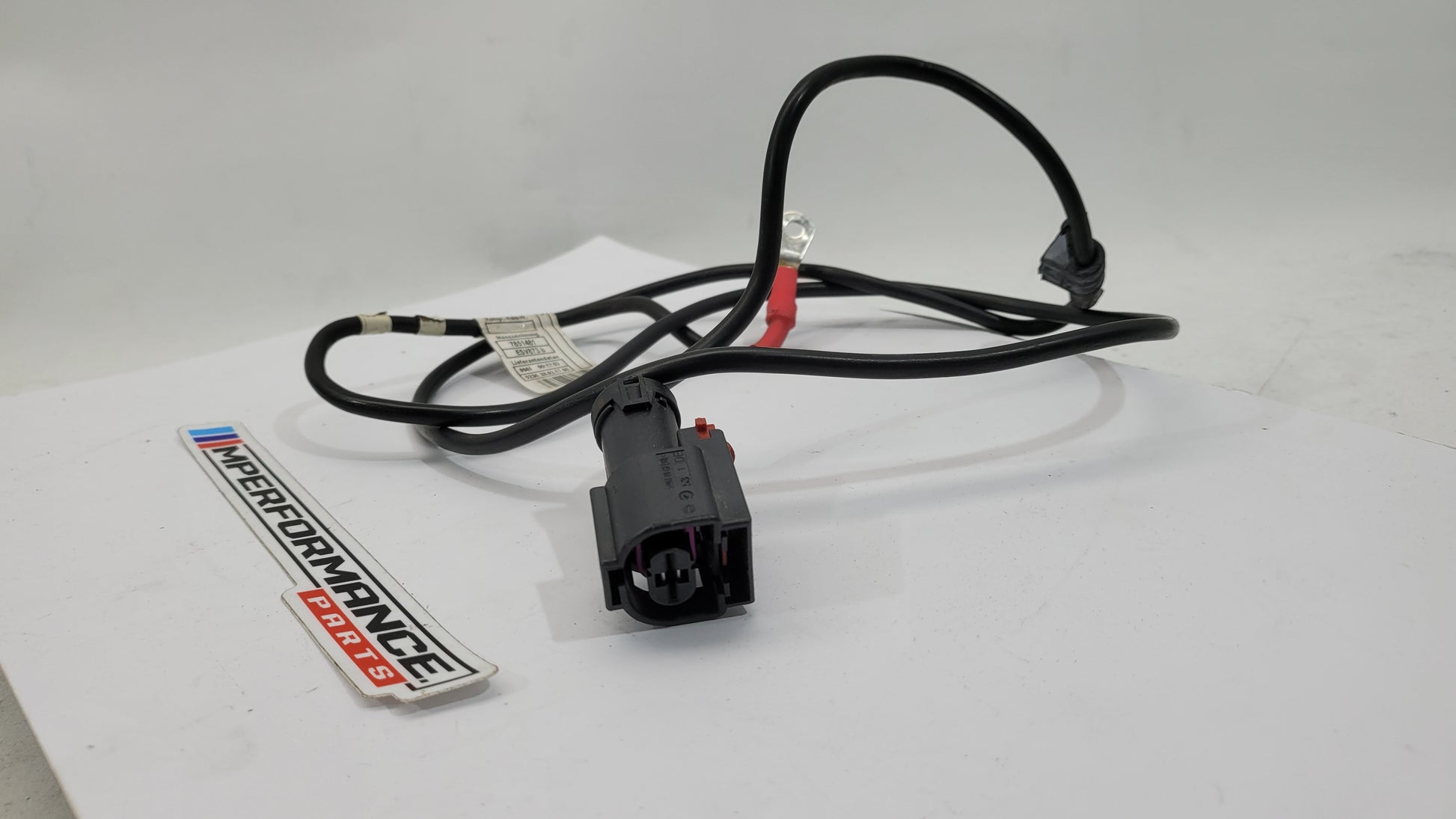 BMW F83 M4 positive battery power distribution cable by MPerformance.parts, showing the cable with connectors and wiring for engine bay use