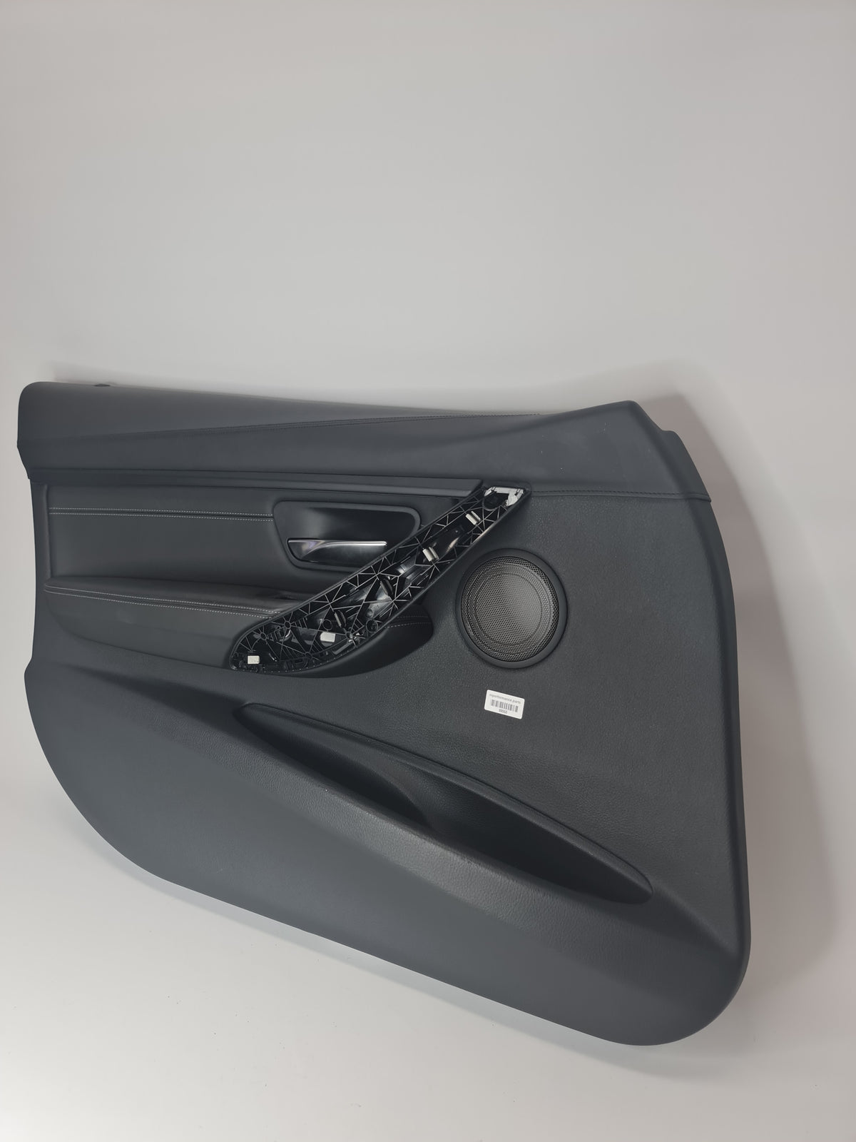 BMW 2012-2019 front left door trim panel in black leather, showing the textured surface and fitment details for the vehicle.